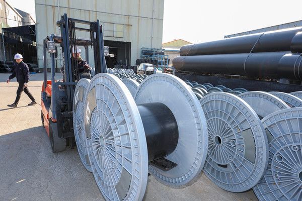 KT 직원이 경기도 김포시에 위치한 아시아플라텍 공장에서 제조된 친환경 보빈을 점검하고 있다./사진=KT