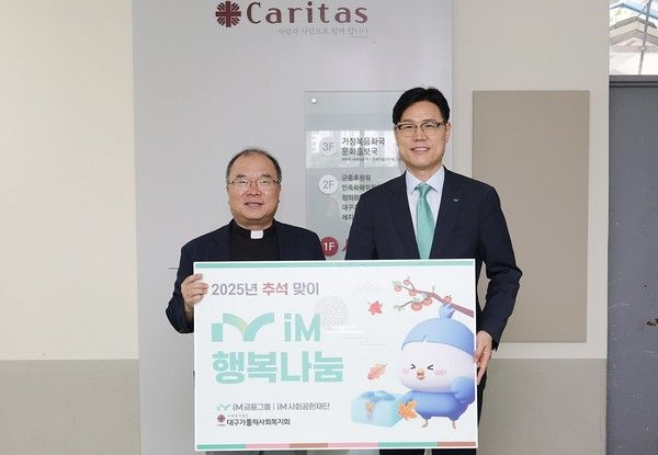 김기진 대구가톨릭사회복지회 대표이사(왼쪽)와 성태문 iM금융지주 그룹가치경영총괄 부사장이 'iM 행복나눔' 전달식에서 기념촬영을 하고 있다. / 사진=iM금융그룹