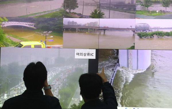 ▲ 서울 종로구 정부서울청사 중앙재난안전상황실 서울상황센터에서 열리는 호우대처 상황 점검회의에 앞서 관계자들이 폭우에 따른 각 지역 영상을 살펴보고 있다. 사진=뉴시스