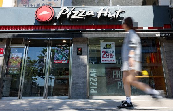▲ 서울 소재 한 피자헛 매장 앞으로 시민이 발걸음을 옮기고 있다. 사진=뉴시스