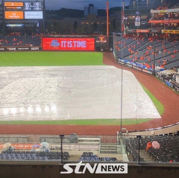 17일 오후 6시 30분 대전 한화생명볼파크에서 열릴 예정이던 2025 신한 SOL뱅크 한국야구위원회(KBO) 포스트시즌(PS) 플레이오프(PO·5전3선승제) 1차전이 비로 순연됐다. 우비를 입은 관중들 속 경기장에 방수포가 덮인 모습. /사진(대전)=이형주 기자
