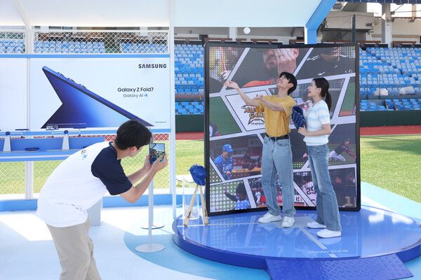 대전 중구 한화 이글스파크 '갤럭시 체험존'에서 방문객들이&nbsp;'갤럭시 Z 폴드7'과 함께 구단별 하이라이트 영상을 배경으로 인증샷을 촬영하는 모습. 삼성전자 제공 [뉴스락]
