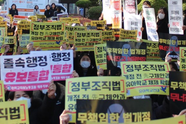 제주유아학교연대 회원들이 지난 7일 오후 제주도교육청 앞에서 정부의 유보통합 추진을 비판하는 손피켓을 들고 있다. [사진제공=뉴시스]