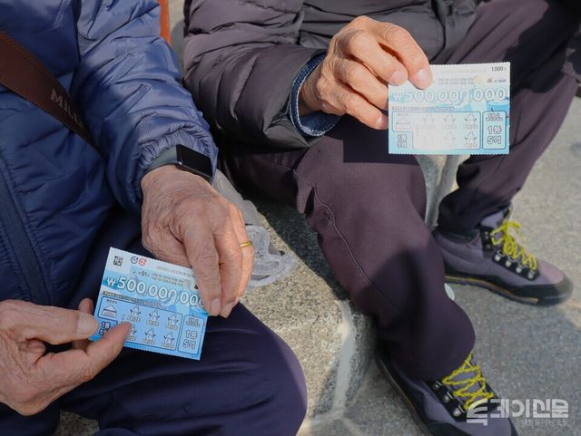 탑골공원 팔각정에 앉아 있던 시민들이 복권을 집어들고 있다.&nbsp;ⓒ투데이신문&nbsp;