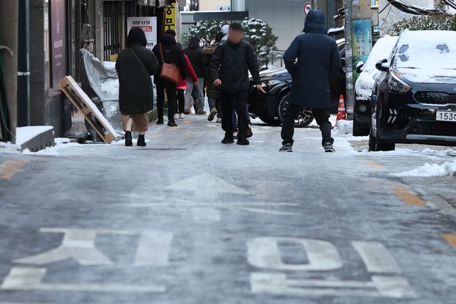 폭설 후 한파로 도로 곳곳이 얼어붙은 5일 오전 서울 중구 충무로역 인근에서 시민들이 빙판길을 조심히 걷고 있다. [사진제공=뉴시스]
