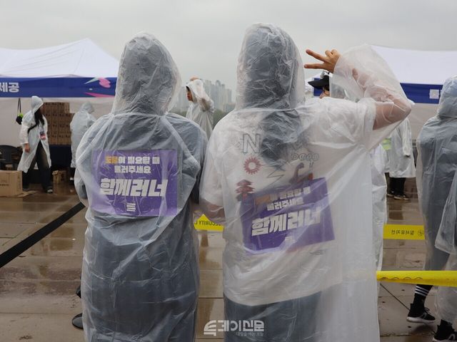 구나경(18) 참가자와 30대 이계선 참가자가 등에 ‘함께러너’ 스티커를 붙이고 있다. ⓒ투데이신문