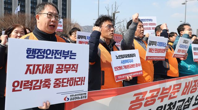 민주일반연맹 공공연대노동조합 관계자들이 지난 10일 서울 종로구 정부서울청사 앞에서 ‘공공부문 비정규직 노동자 대정부 원청교섭 요구 기자회견’에서 손 피켓을 들고 있다. [사진제공=뉴시스]<br>