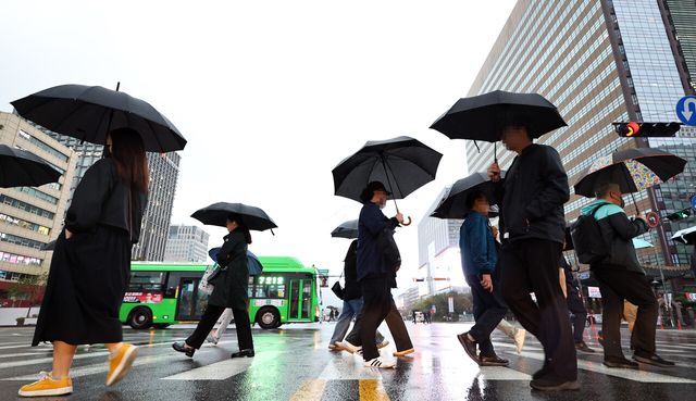 지난해 10월 10일 서울 종로구 세종대로 사거리에서 시민들이 우산을 쓴 채 길을 걷고 있다. [사진제공=뉴시스]