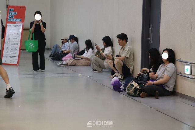 24일 열린 ‘2026 서울국제도서전’에서 휴게공간이 없어 관람객들이 바닥에 앉아 휴식을 취하고 있다. ©투데이신문<br>