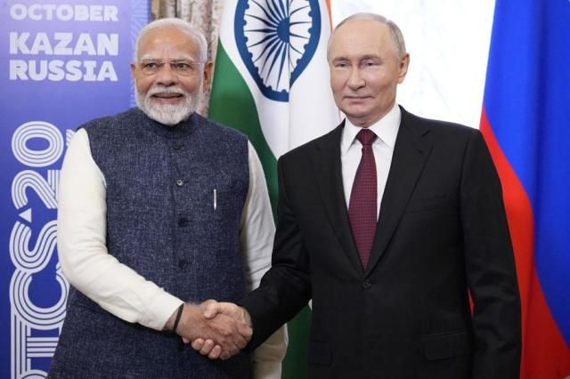 Indian Prime Minister Narendra Modi left and Russian President Vladimir Putin shake hands during their meeting on the sidelines of BRICS Summit at Kazan Kremlin in Kazan Russia on Oct 22 2024 AP-Yonhap
