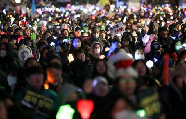 Protesters hold a candlelight vigil in front of the National Assembly in Yeouido Seoul on Dec 12 2024 demanding the impeachment of President Yoon Suk Yeol Yonhap