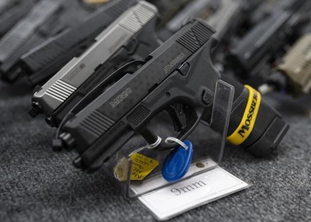 Pistols sit on display during the first day of the Silver Spur Gun and Blade Show in Odessa Texas on Jan 22 2022 AP-Yonhap