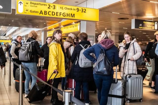 Travelers wait inside Schiphol Airport outside of Amsterdam the Netherlands on April 28 2024 AP-EPA