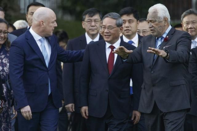 Chinese Premier Li Qiang center is escorted by New Zealands Prime Minister Christopher Luxon left and Maori tribal elder Joe Harawira right during the official welcome ceremony in Wellington New Zealand on June 13 2024 AP-Yonhap