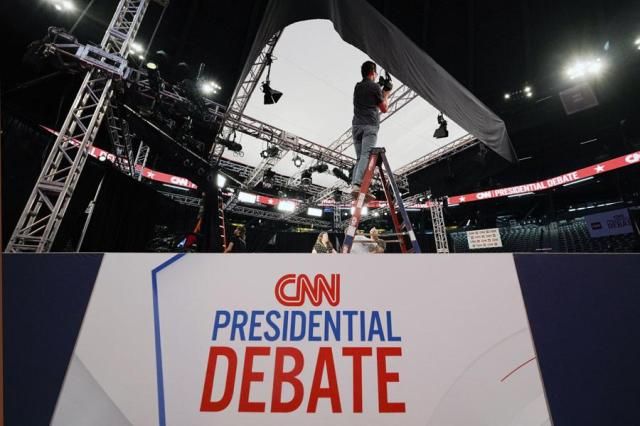 Ben Starett lighting programmer for CNN sets up lights in the spin room for the presidential debate between President Joe Biden and Republican presidential candidate former President Donald Trump in Atlanta on June 26 2024 AP-Yonhap