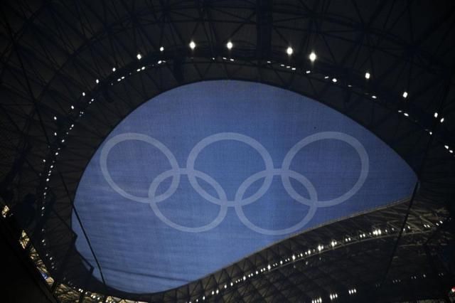 The Olympic rings are pictured through a flag hanging in the Velodrome stadium before the start of the mens Group A soccer match between France and the United States during the 2024 Summer Olympics in Marseille France on July 24 2024 AP-Yonhap
