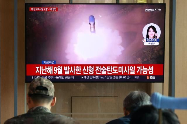 People watch a TV screen showing a news program reporting about North Koreas missile launch at a train station in Seoul on Oct 22 2025 Yonhap