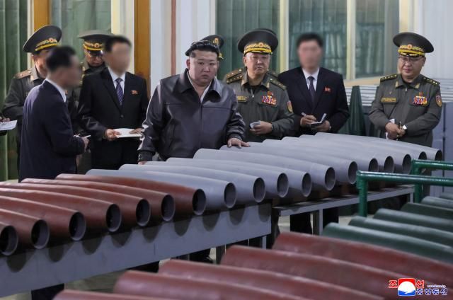 North Korean leader Kim Jong-un center inspects a munitions factory at an undisclosed location in Pyongyang on May 11 2026 in this photo released by the state-run North Korean Central News Agency two days later