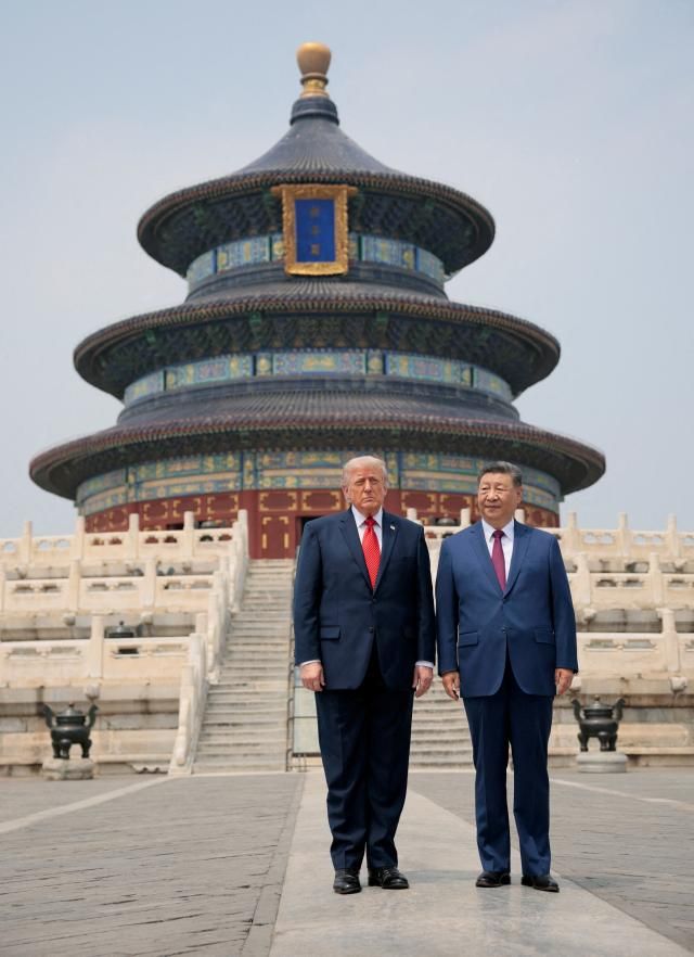 US President Donald Trump and Chinese President Xi Jinping stand together as they tour the Temple of Heaven in Beijing China May 14 2026 REUTERSYonhap