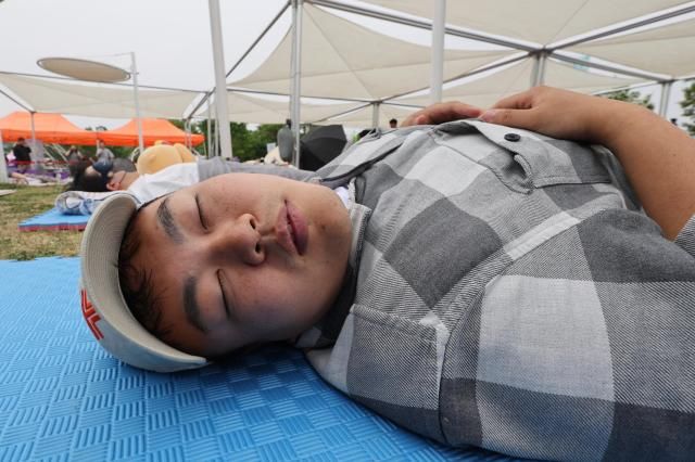 Joonha Yoo a journalist of AJU Press is partaking in a 2026 Han River Napping Championship held at Mulbit Plaza in Yeouido Hangang Park Yeongdeungpo-gu Seoul May 2 2026 AJP Han Jun-gu