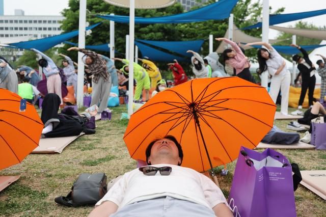 A participant sleeps at the 2026 Han River Napping Championship held at Mulbit Plaza in Yeouido Hangang Park Yeongdeungpo-gu Seoul May 2 2026 AJP Han Jun-gu