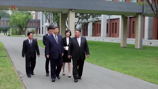 North Korean leader Kim Jong Un L and Chinese President Xi Jinping walk and talk on the grounds of the Workers Party of Korea Central Cadres Training School in Pyongyang on June 9 2026 during Xis state visit to North Korea Following behind them is Ri Yong Sik principal of the Central Cadres Training School Korean Central Television footage via Yonhap