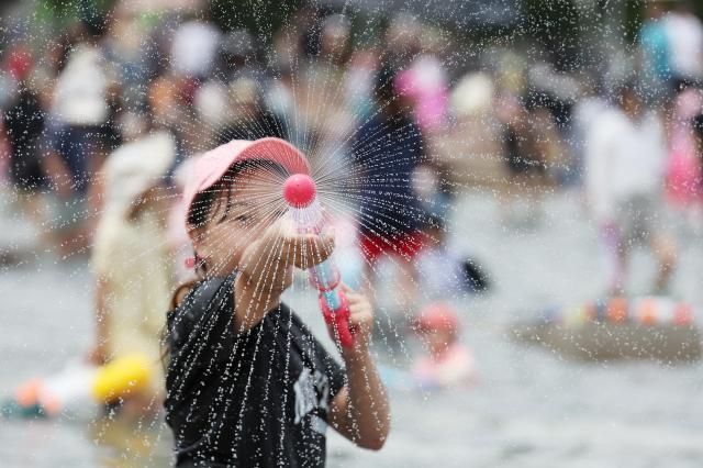 A visitor at Yeouido Hangang Park in Seoul cools off with water June 3 2026 Yonhap