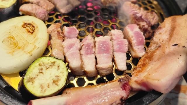 This photo shows pork belly being grilled alongside onions and various vegetables Courtesy of National Institute of Animal Science 