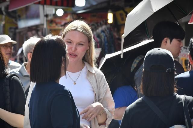 A foreign tourist shops for accessories at a stall inside Namdaemun Market in central Seoul Sept 22 2026 AJP Joonha Yoo