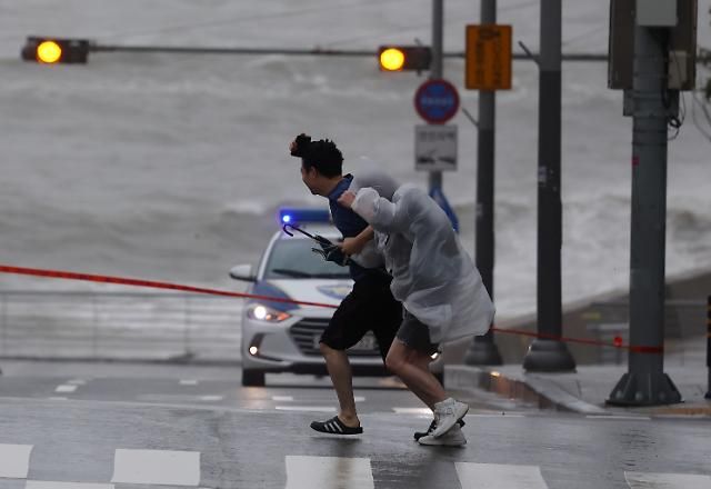 Người dân vật lộn với gió mạnh gần cảng Mipo ở Busan vào sáng ngày 1082023 ẢnhYonhap News