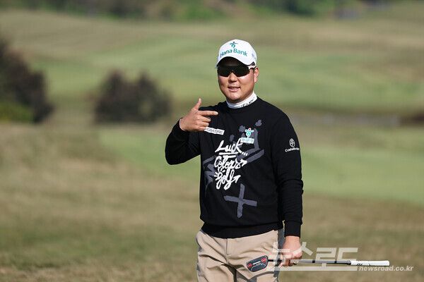 함정우가 18번홀 페어웨이에서 렉서스를 의미하는 'L'자 모양 포즈를 취하고 있다./사진=KPGA