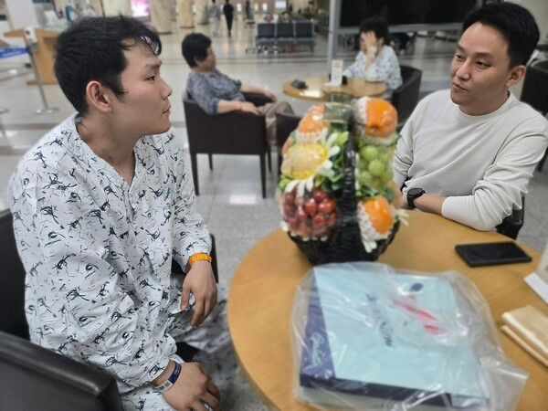 사진: 서울아산병원 로비에서 간이식 수술을 마친 서동훈 씨(왼쪽)와 HR그룹 관계자(오른쪽)가 그의 쾌유를 기원하며 담소를 나누고 있다. / 제공: HR그룹㈜ 미디어팀