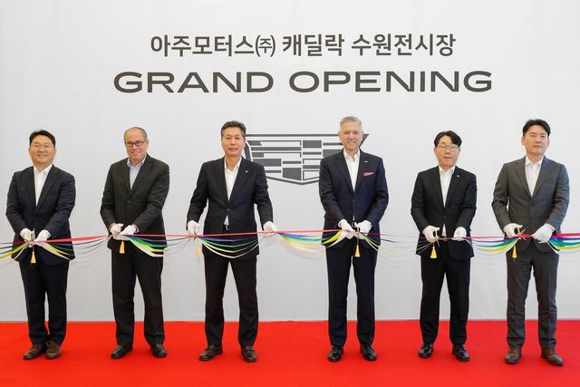 27일 열린 캐딜락 수원 전시장 오픈 기념식에서&nbsp;(오른쪽 세 번째)&nbsp;헥터 비자레알(Hector Villarreal) GM&nbsp;한국사업장 사장과&nbsp;(왼쪽 세 번째)&nbsp;최광석 ㈜아주모터스 대표이사를 비롯한 양사 임직원들이 테이프 커팅을 진행하고 있다.
