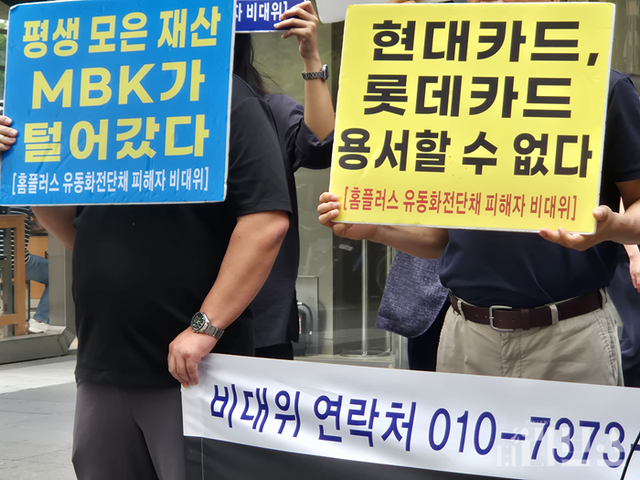 투자자들이 ‘평생 모은 재산 MBK가 털어갔다’, ‘현대카드, 롯데카드 용서할 수 없다’고 적힌 피켓을 들고 있다. [사진=임서우 기자]