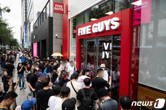 미국 햄버거 브랜드 파이브가이즈 1호점 오픈일인 26일 서울 강남구 파이브가이즈 강남 매장 앞에 입장을 기다리는 고객들이 길게 줄지어 서 있다. 2023.6.26/뉴스1 ⓒ News1 유승관 기자