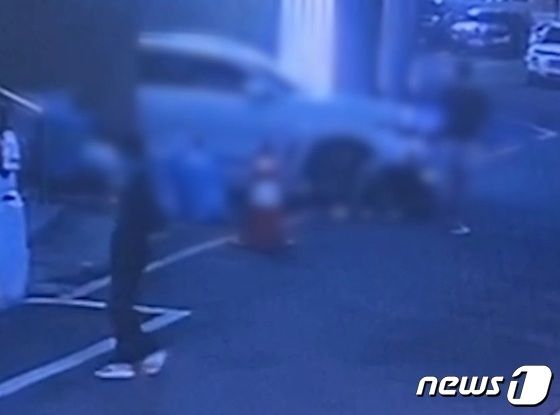 27일 오전 0시40분께 부산 부산진구 부전동 한 골목길에서 10대 남자 2명이 20대 남성 피해자를 폭행하고 있는 모습. 사진 왼쪽이 피해자와 오픈 채팅방으로 만나게 된 10대 여성. (부산경찰청 제공)