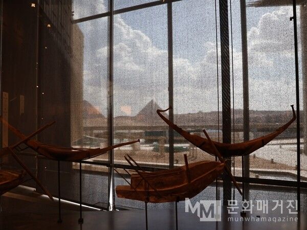 ▲ 실제 크기로 재현된 고대 이집트의 목선들이 진열되어 있으며, 창문을 통해 멀리 기자 피라미드의 실루엣이 보이는 전경 / 사진: 한민광 제공