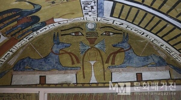 ▲ 룩소르 노동자의 마을 센누템의 무덤. 센누템 무덤 입구 정면의 벽화에는 죽은 자를 보호하는 아누비스 신과 이집트의 상징인 '두 개의 눈'이 함께 그려져 있다. 이는 사후 세계에서의 재생과 보호, 그리고 태양과 달의 영원한 순환을 상징한다 / 사진: 한민광 제공