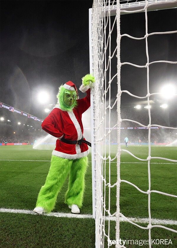 ▲21일 영국 런던의 셀허스트 파크에서 열린 크리스탈 팰리스 FC와 아스널 FC의 프리미어 리그 경기에서 그린치로 분장한 공연자 (사진=gettyimagesKOREA)