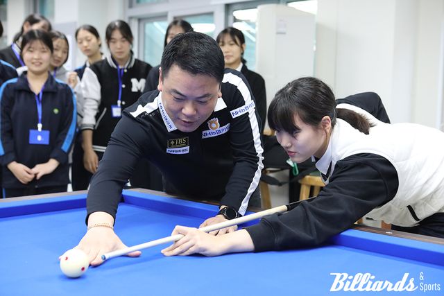 처음 큐를 잡아 본 학생들에게 당구에 대해 설명하는 조재호.