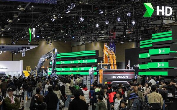 2025 서울모빌리티쇼_HD현대 부스의 굴착기 신모델과 관람객들.
