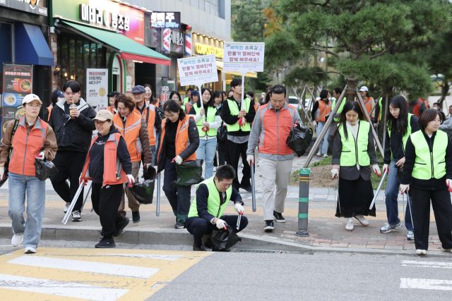 김정헌 인천 중구청장(가운데)이 ‘쾌적한 초록길 만들기’ 캠페인에 참여해 쓰레기를 줍고 있다. 중구청 제공