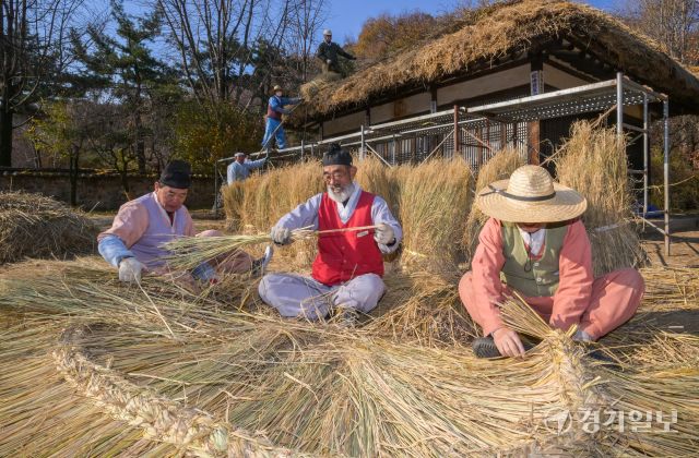절기상 소설을 사흘 앞둔 19일 오후 용인특례시 한국민속촌에서 직원들이 초가지붕에 올릴 용마름과 이엉을 얹고 있다. 윤원규기자