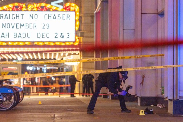 Chicago police investigate the scene of a shooting outside the Chicago Theater in The Loop, Friday, Nov. 21, 2025. (Tyler Pasciak LaRiviere/Chicago Sun-Times via AP) MANDATORY CREDIT; CHICAGO TRIBUNE OUT