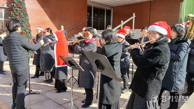 성탄절을 나흘 앞둔 21일 오전 수원특례시내 한 교회 앞에서 산타복을 입은 오케스트라 대원들이 다양한 크리스마스 캐럴을 연주하며 성탄 분위기를 고조시키고 있다. 김시범기자
