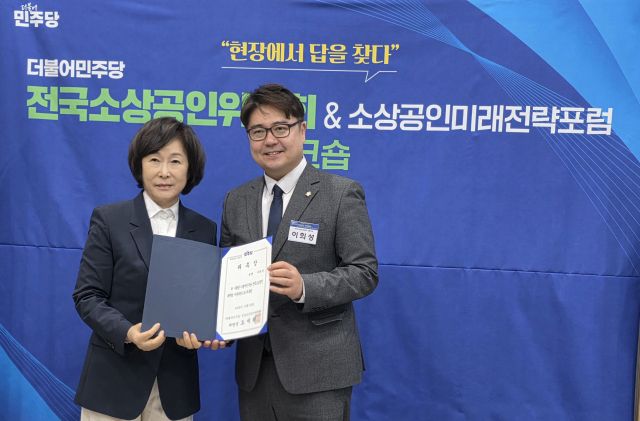 이희성 김포시의원(오른쪽)이 오세희 국회의원(더불어민주당 전국소상공인위원장)으로부터 자문위원 위촉장을 받고 있다. 이희성 시의원 제공