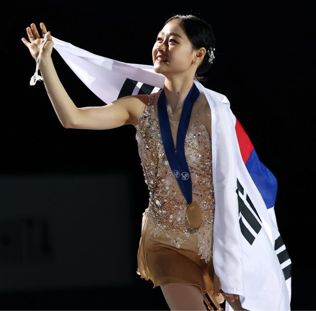 23일 서울 목동 아이스링크에서 열린 2025 국제빙상경기연맹(ISU) 4대륙 피겨 선수권대회 여자 싱글에서 금메달을 획득한 김채연이 태극기를 두르고 관중에게 인사하고 있다.연합뉴스
