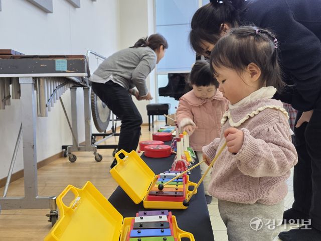 이날 본격적인 수업이 시간되기 전 체험공간에 자리한 이윤슬 어린이(사진 앞쪽, 16개월) 등 영유아 참여자들이 다양한 악기를 만져보고 있다. 이나경기자