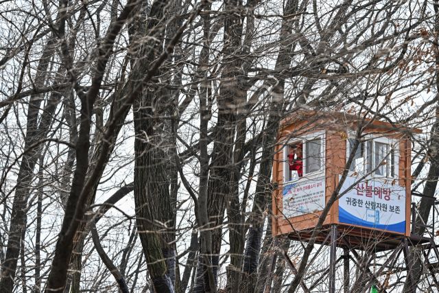 24일 오전 군포시 수리산 밤바위 산불감시초소에서 민인기 산불전문진화예방대원이 수리산 자락을 지켜보고 있다. 윤원규기자