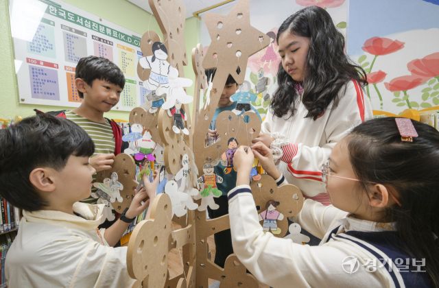 세계 책의 날을 하루 앞둔 22일 오전 수원특례시 영통구 효동초등학교 도서관에서 학생들이 본인의 추천 도서를 적어 독서나무에 걸고 있다. 윤원규기자